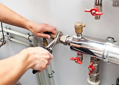 The,Man,Is,Installing,The,Heater,System,In,The,House